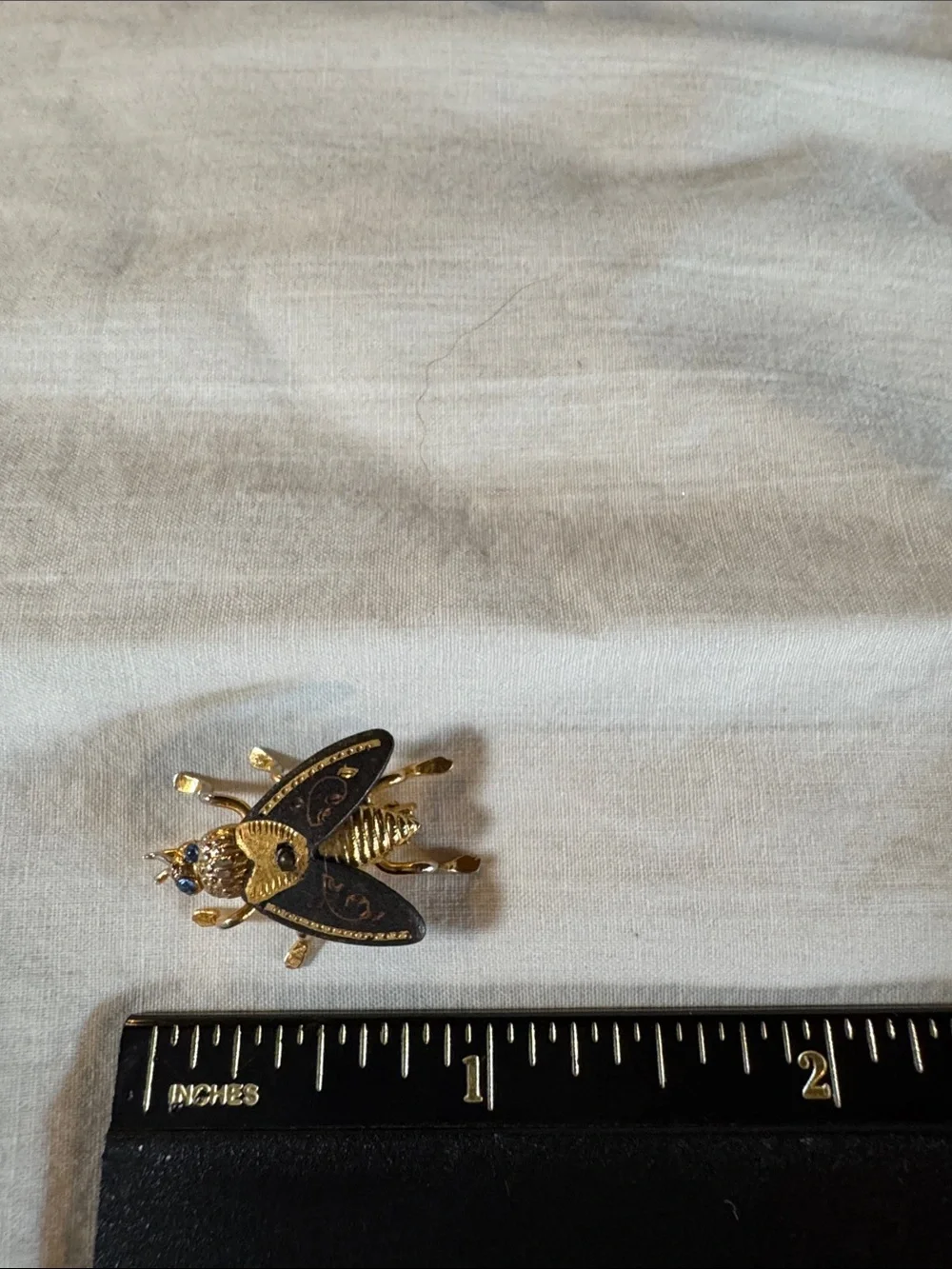 Gold Tone Bee Brooch with Black Enamel and Blue Rhinestones